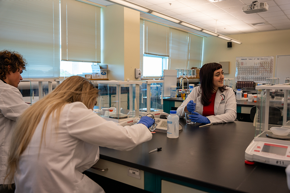 student in lab working with medical scales