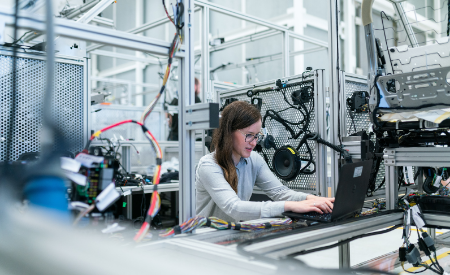 students working on a computer in an engineering lab