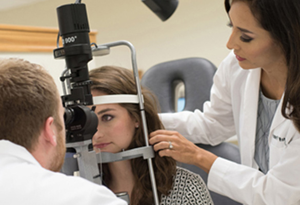UIW students giving eye exam