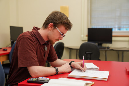student studying with a pencil and notebook