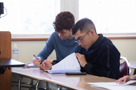 students studying with pens and paper