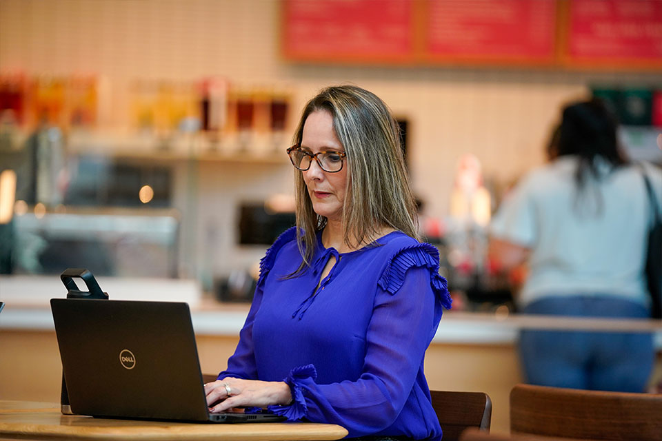 Woman sitting at desk working on computer