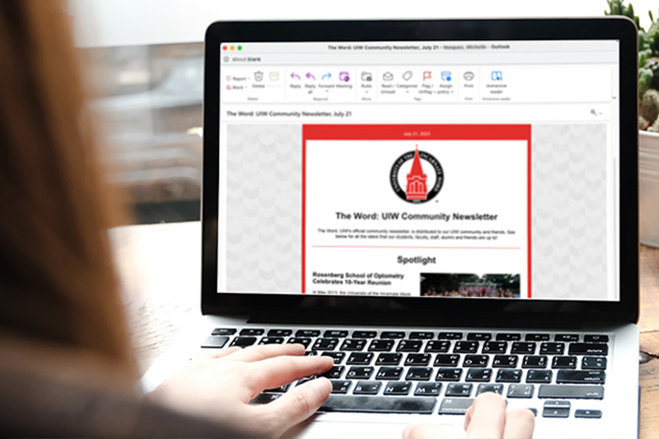 woman at computer looking at newsletter