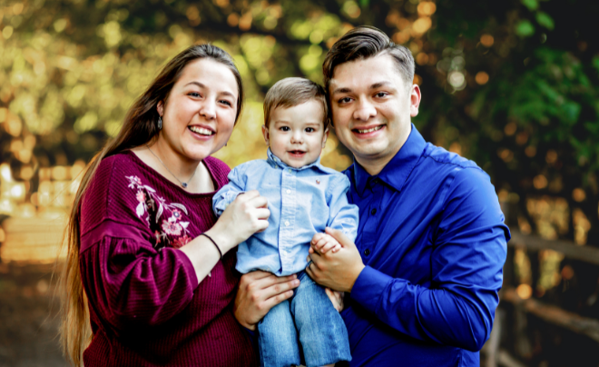 Michael Lesley, wife Brittany, and son smile at the camera