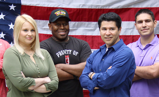 military students posing in front of an American flag