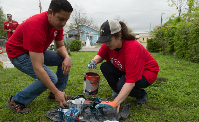 Students pour paint into buckets