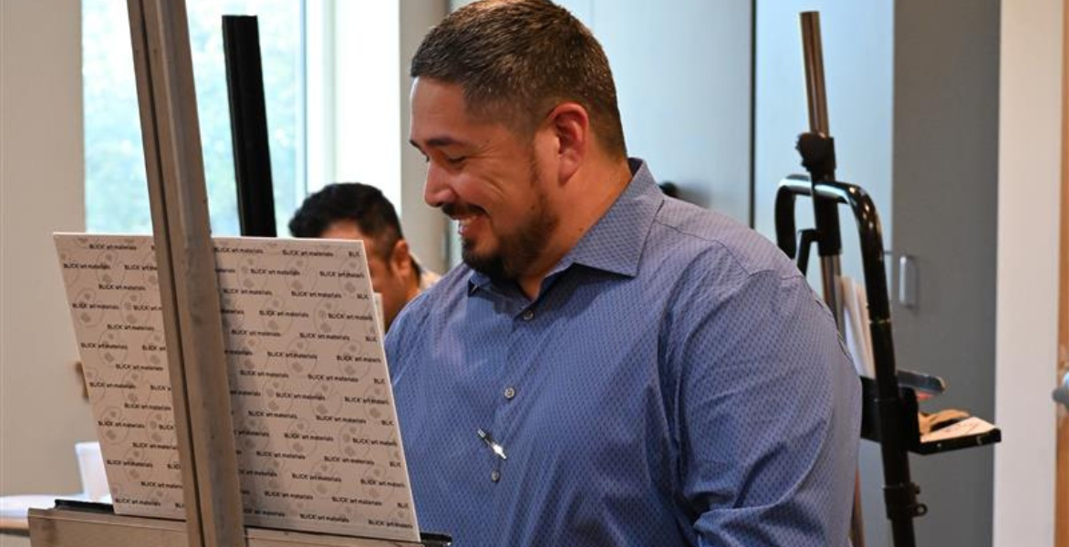 Artist smiling while painting