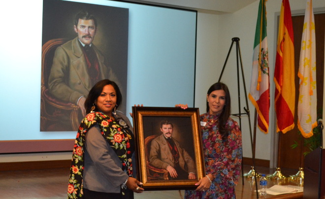 Two women holding a forensic portrait