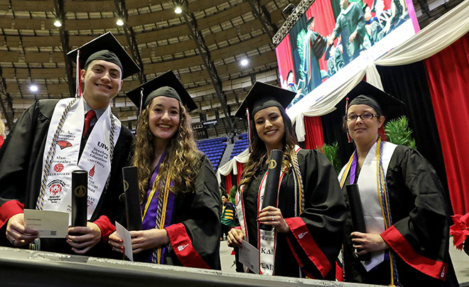 Students in cap and gown at Graduation