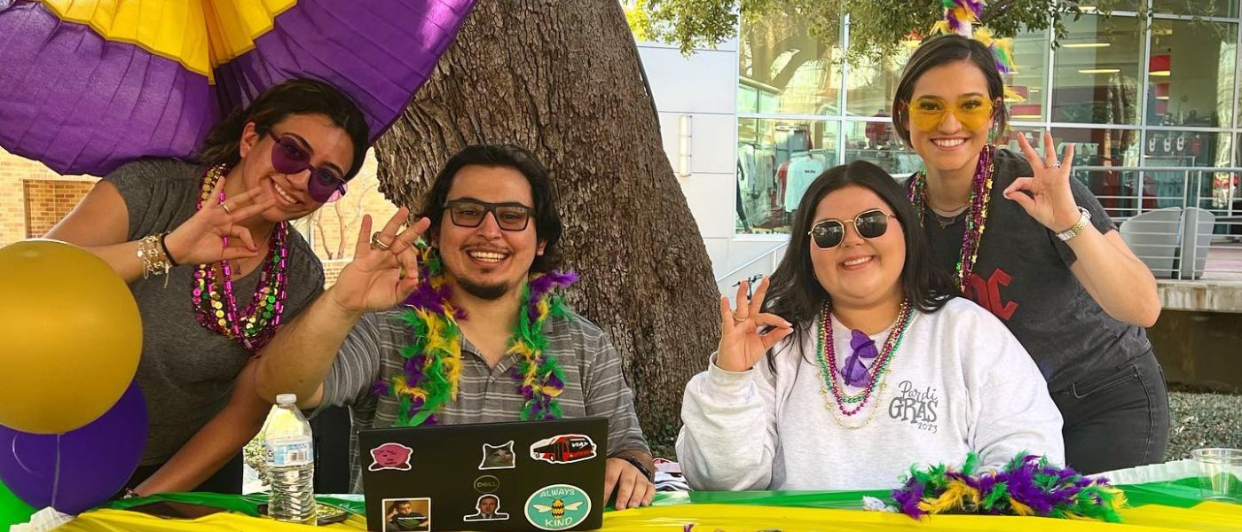 Staff smiling during Pardi Gras