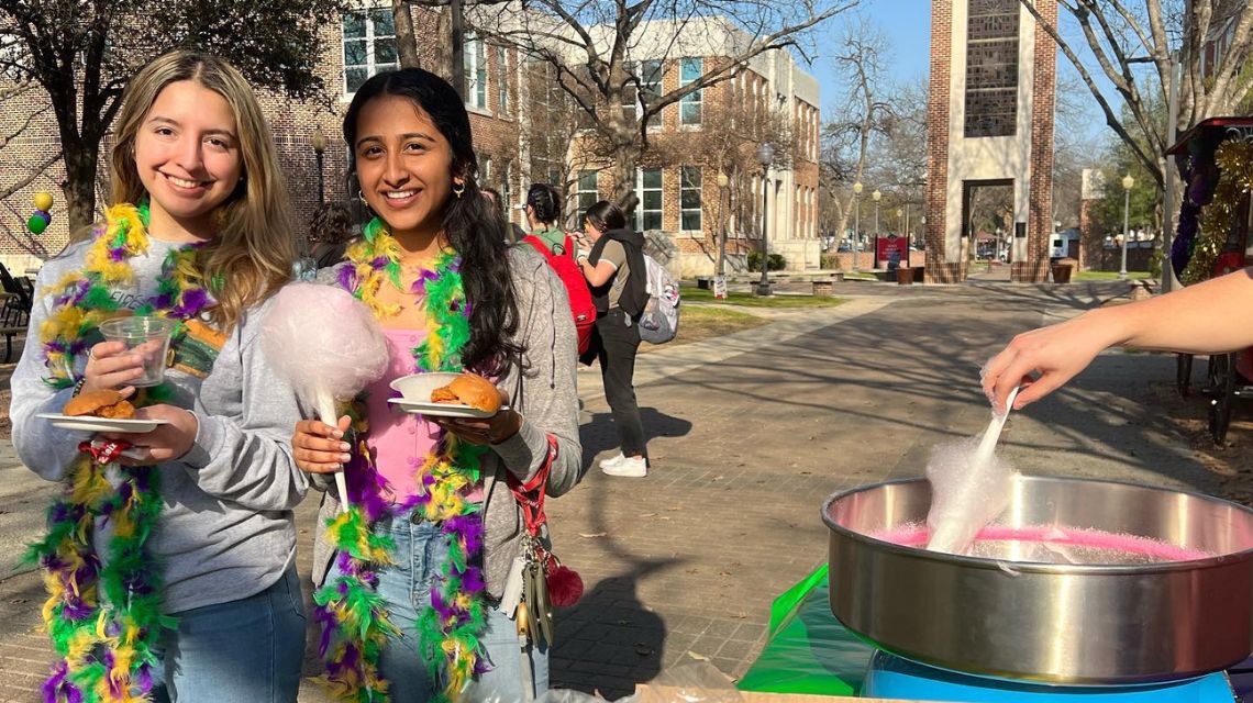 Two students smile during Pardi Gras