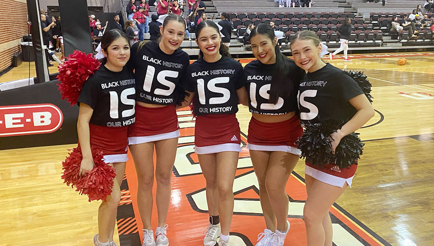 Cheer leaders in Black Out for Black History shirts