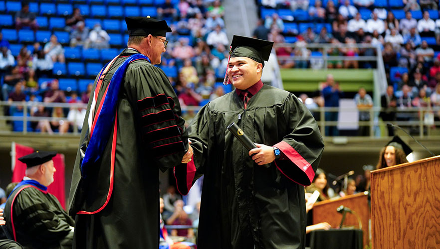 Graduate shaking Dr. Evans's hand