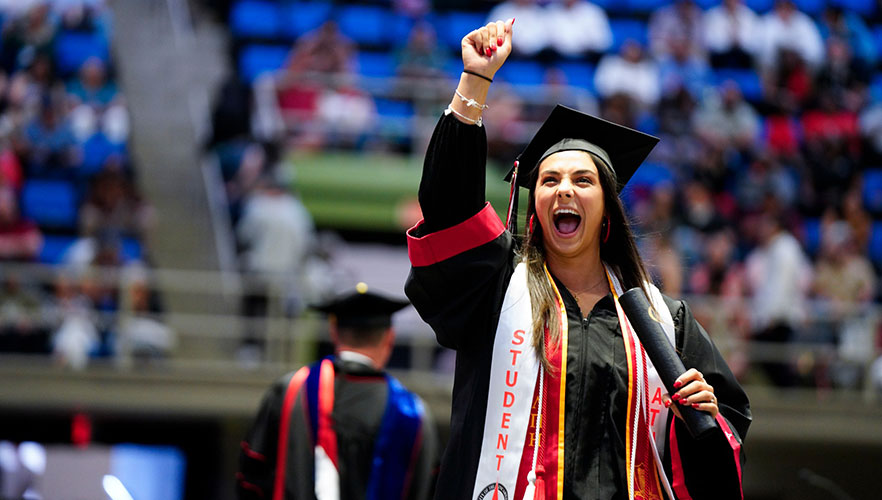 Graduate smiling on stage