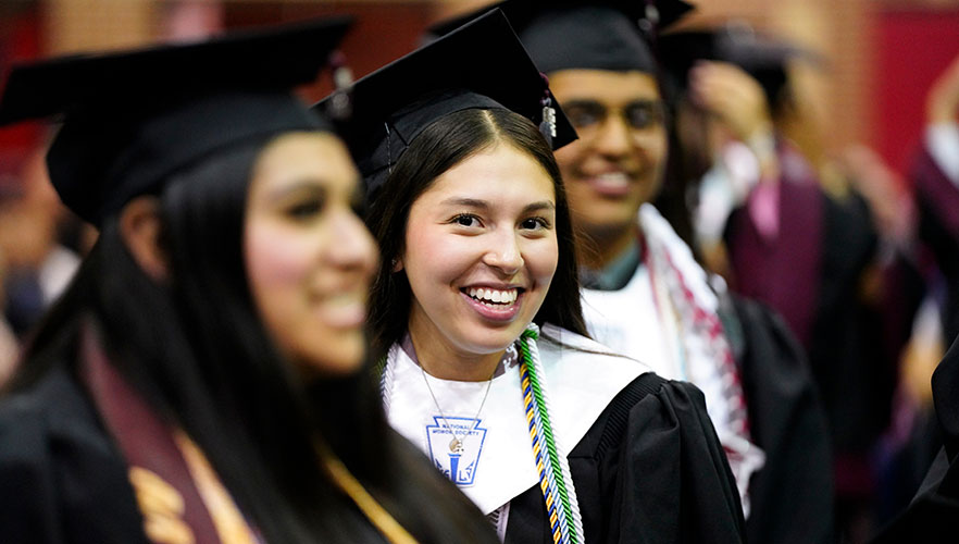 student smiling in crowd