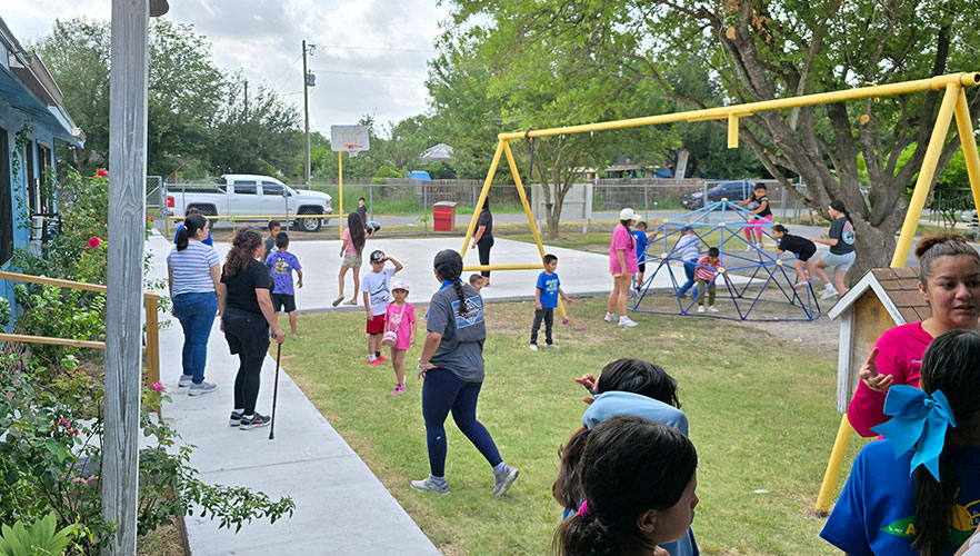 ARISE children playing on playground with UIW students