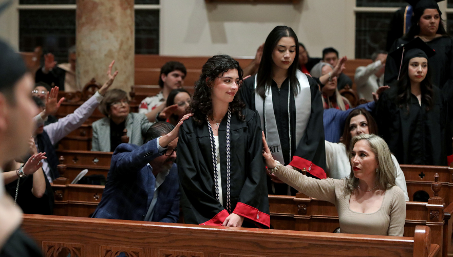 Graduates being prayed over by family