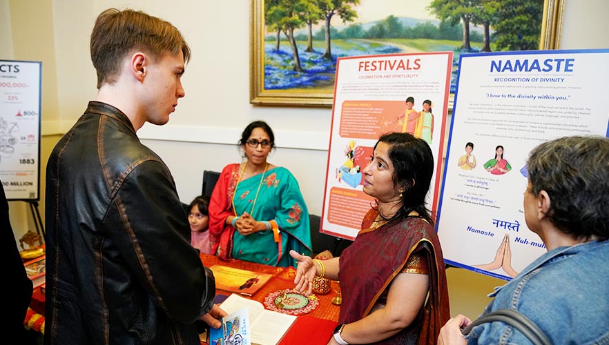 guest listening to poster presentation