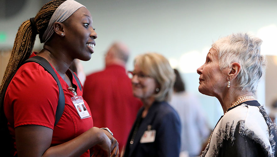 Dr. Jean Watson talking with nursing student