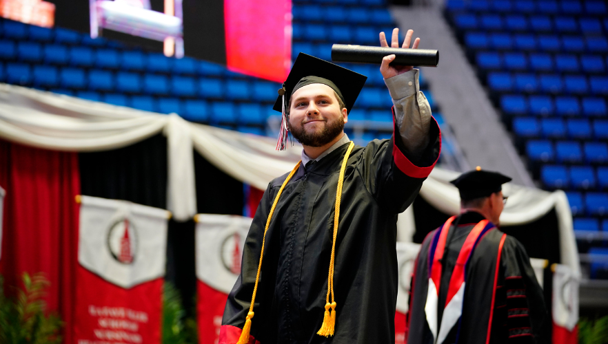 Graduate waving