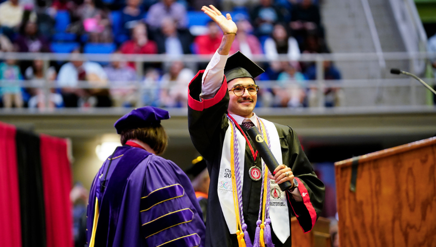 Graduate waving
