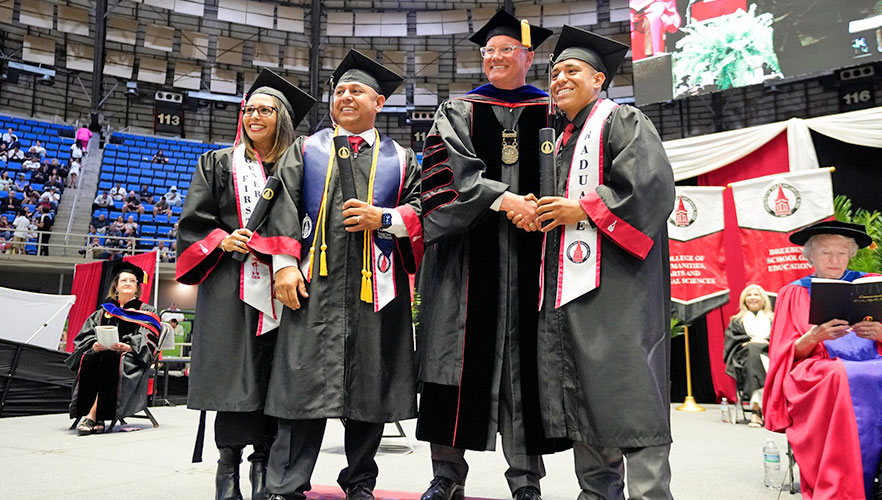 Graduating family standing with Dr. Thomas M. Evans, Ph.D.