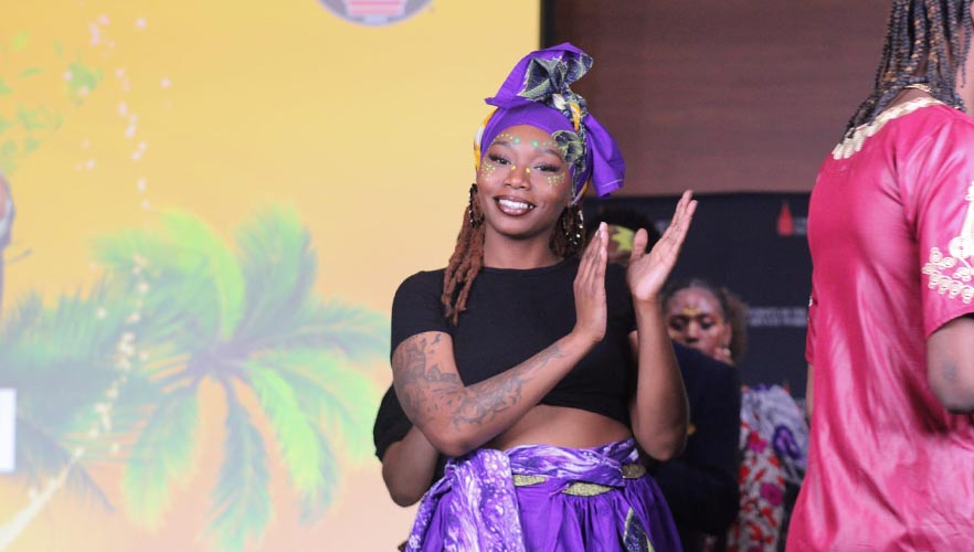 Fashion model clapping wearing purple dress