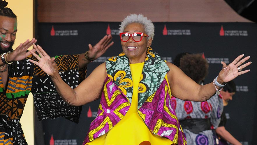 Fashion model with hands up smiling