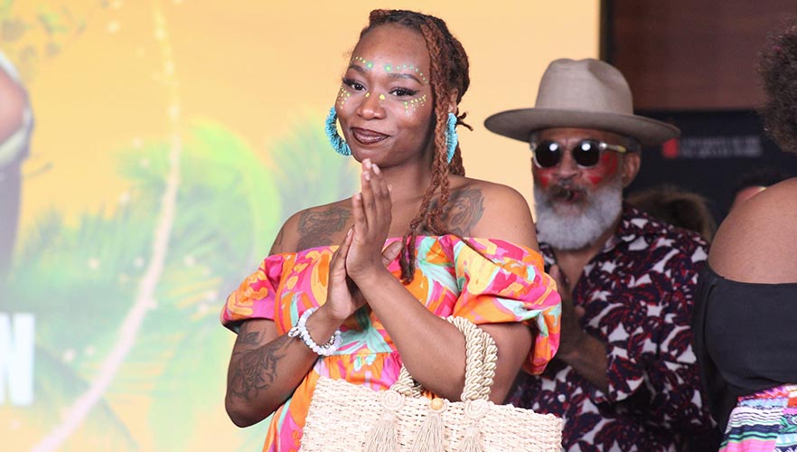 Fashion model wearing dress clapping hands