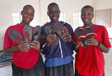 Students with shoes they created