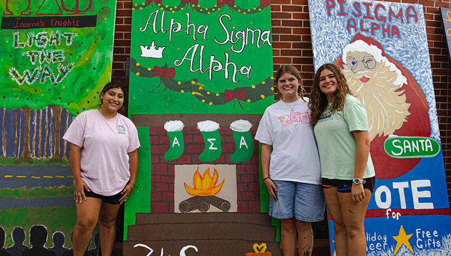 Alpha Sigma Alpha members and display board