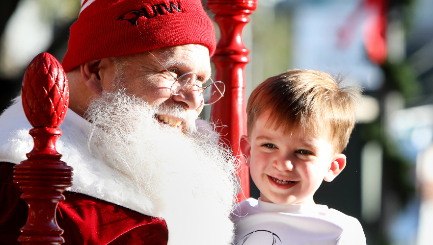 Kid smiling with Santa Claus