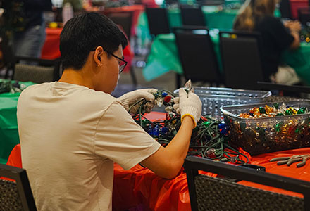 Student volunteer preparing Light the Way lights