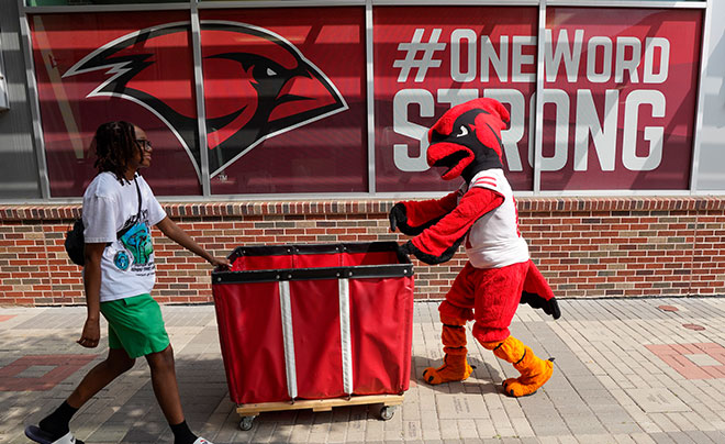 Red the Cardinal helping to move in students