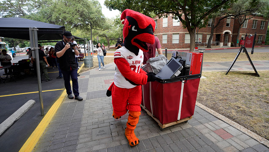 Red the Cardinal helping students to move-in