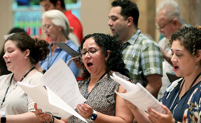Attendees singing in chapel