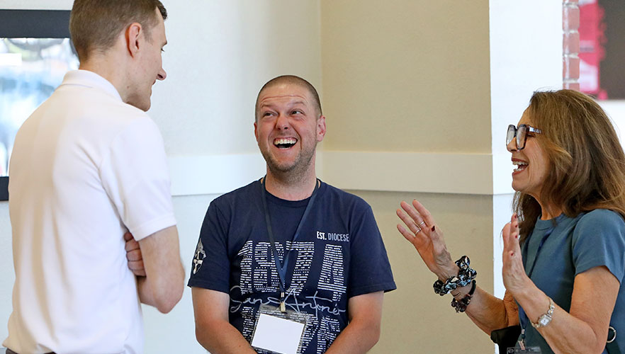 Attendees smiling and laughing