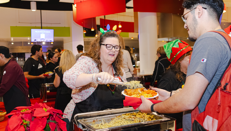 UIW staff serving students food