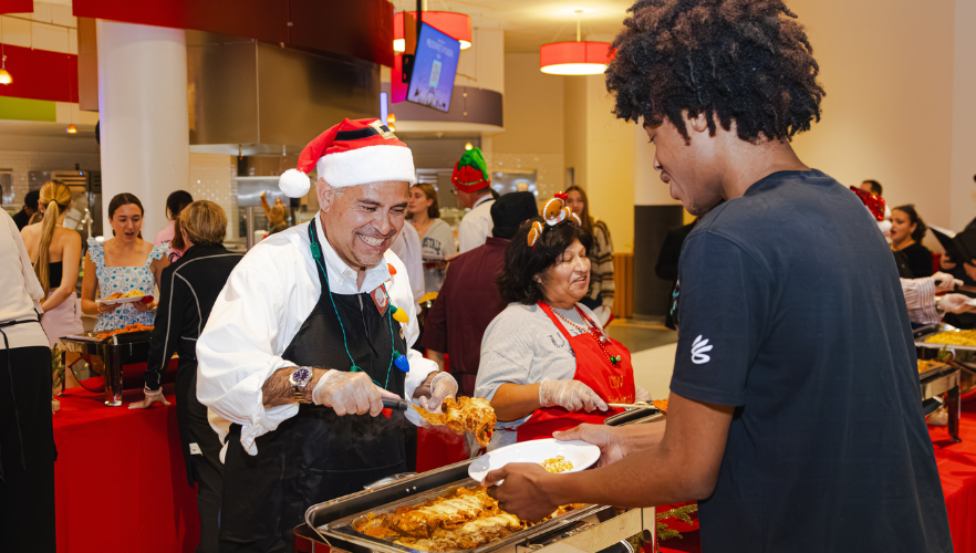 UIW staff serving students food