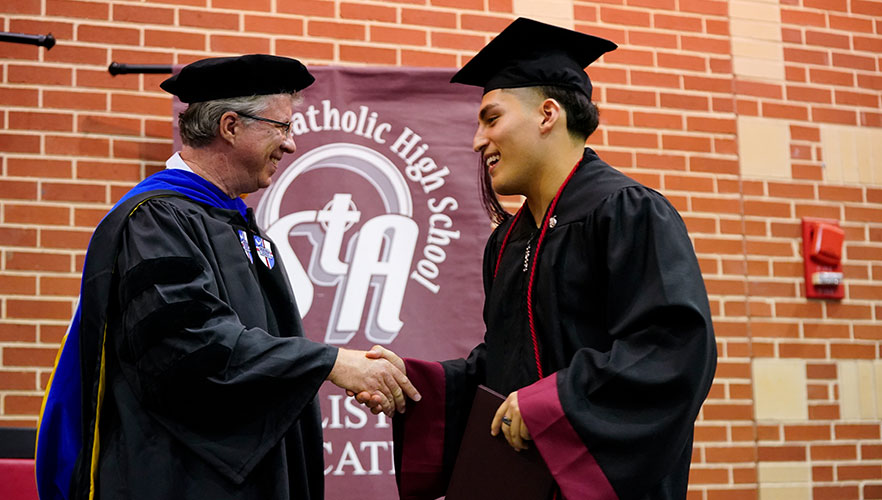 St. Anthony Catholic High School graduate receiving diploma 