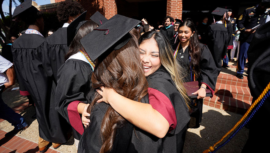 St. Anthony Catholic High School graduates hugging
