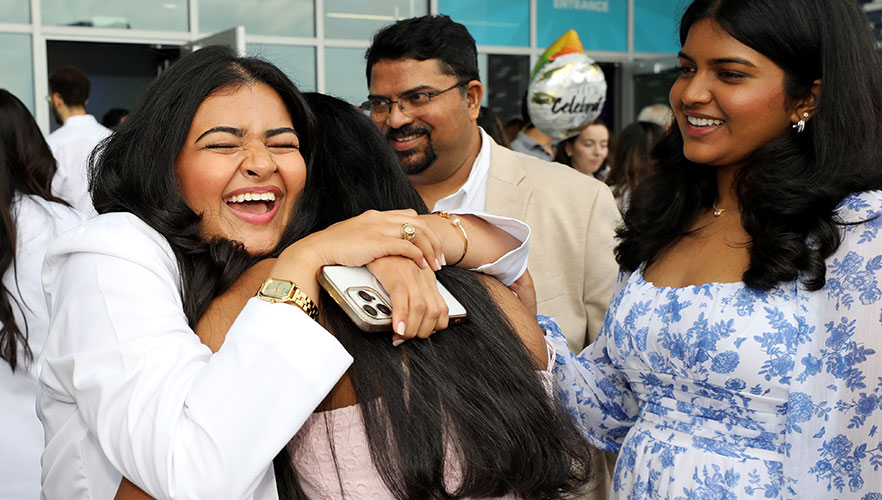 Student being hugged by family