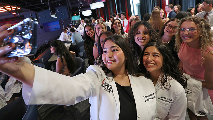 Students taking selfie with other students in celebration