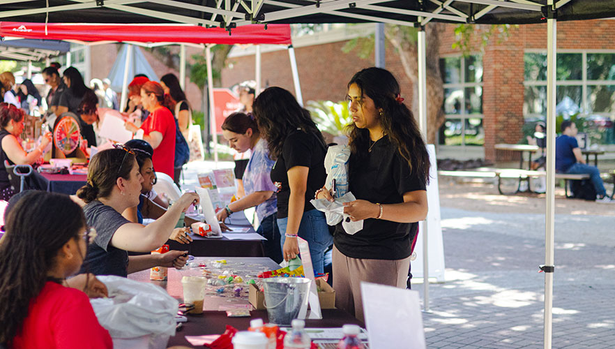 Student talking with representatives as tables