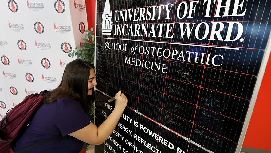 participant signing solar panel
