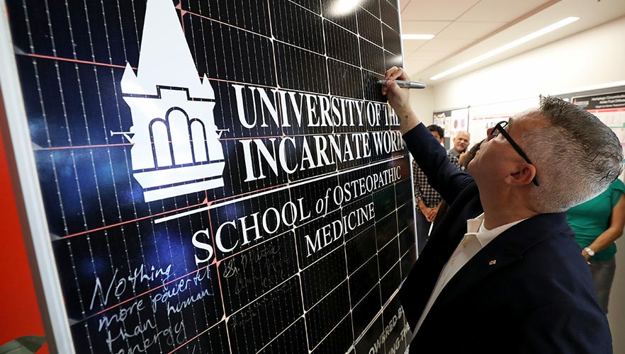 participants signing solar panel