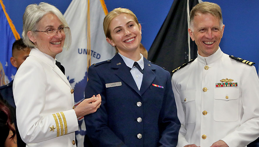 UIWSOM graduate at ceremony with family
