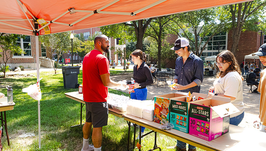 Ettling member handing out BBQ