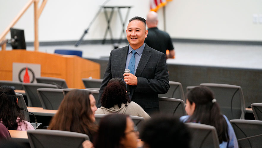 Dr. Pham talking with students
