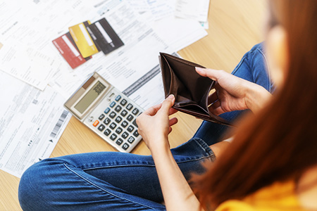 student with bills on floor